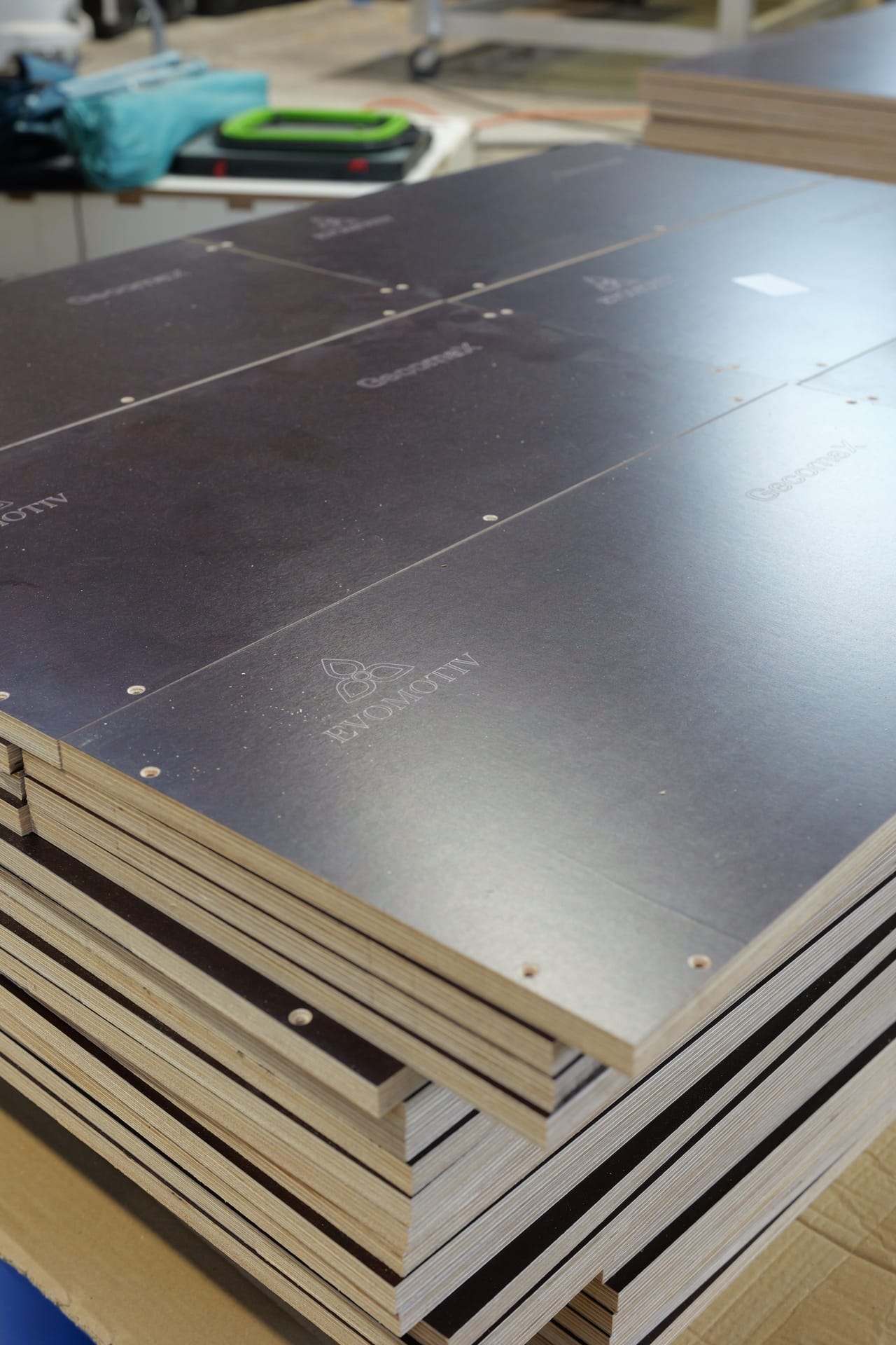 Vertical view of a stack of film-faced plywood parts with engraving