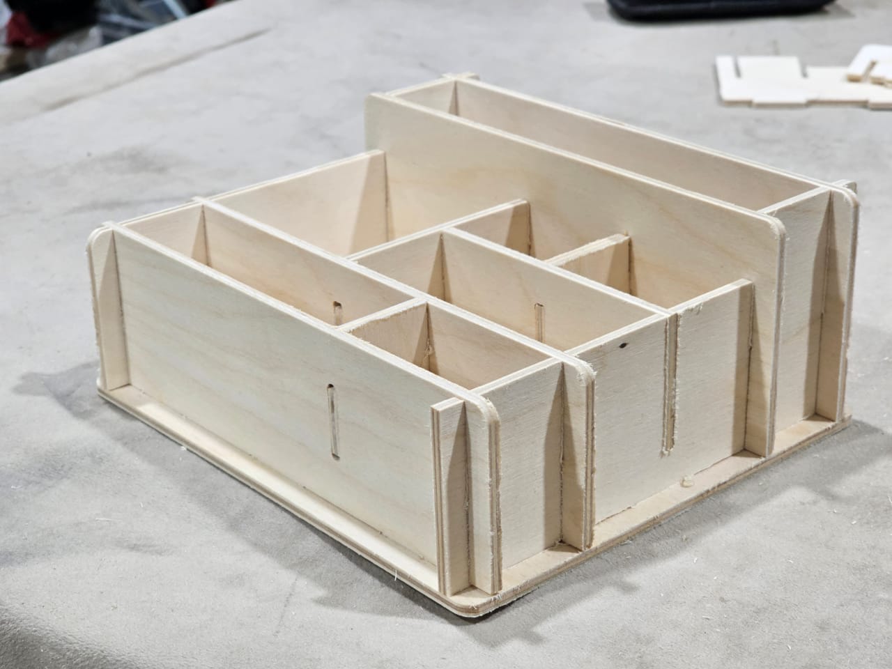 Plywood tray with interlocking dividers, a protective insert for small parts