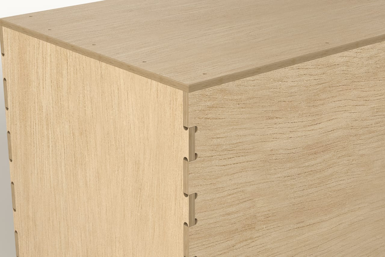 Close-up of a CNC-cut finger joint with full-thickness tenons on the corner of a plywood crate